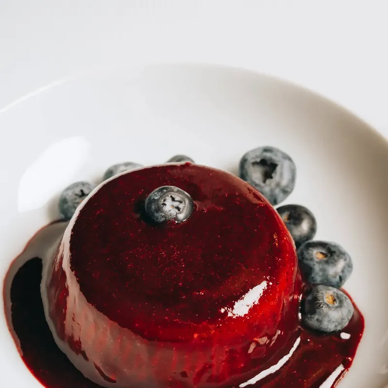 Panna cotta with berry sauce and blueberries